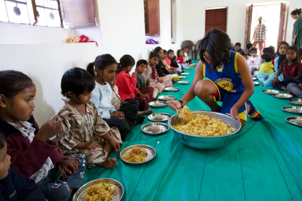 Serving chicken and rice to kids in India