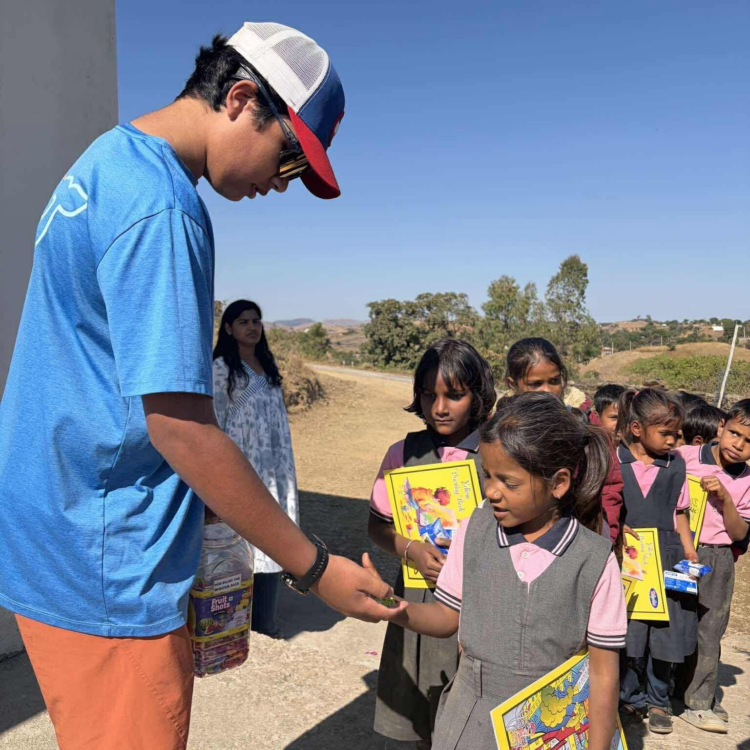 Handing out school supplies to kids in India